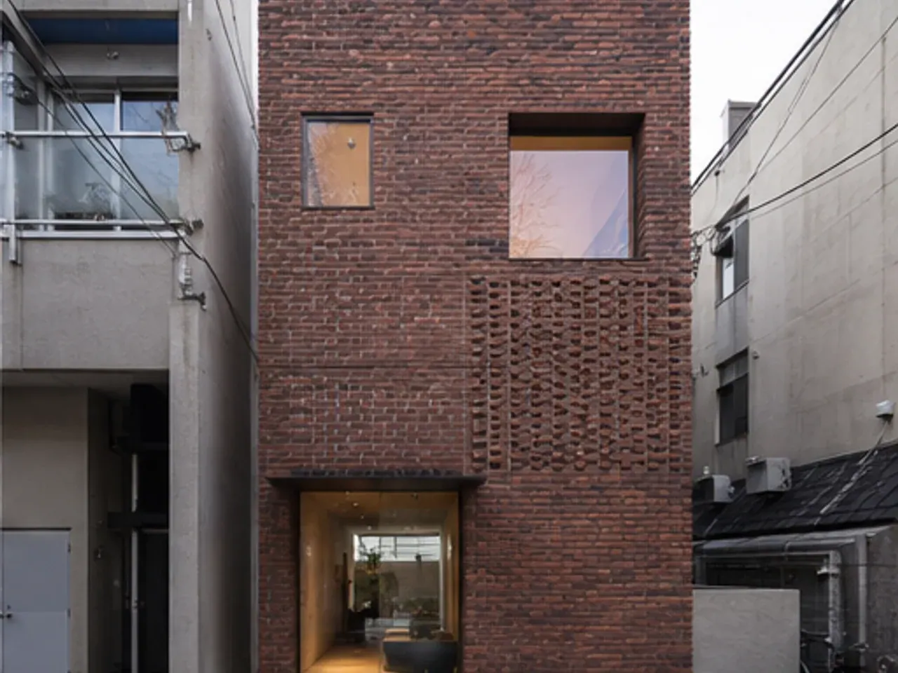 Old brick wall with a new steel-framed insertion