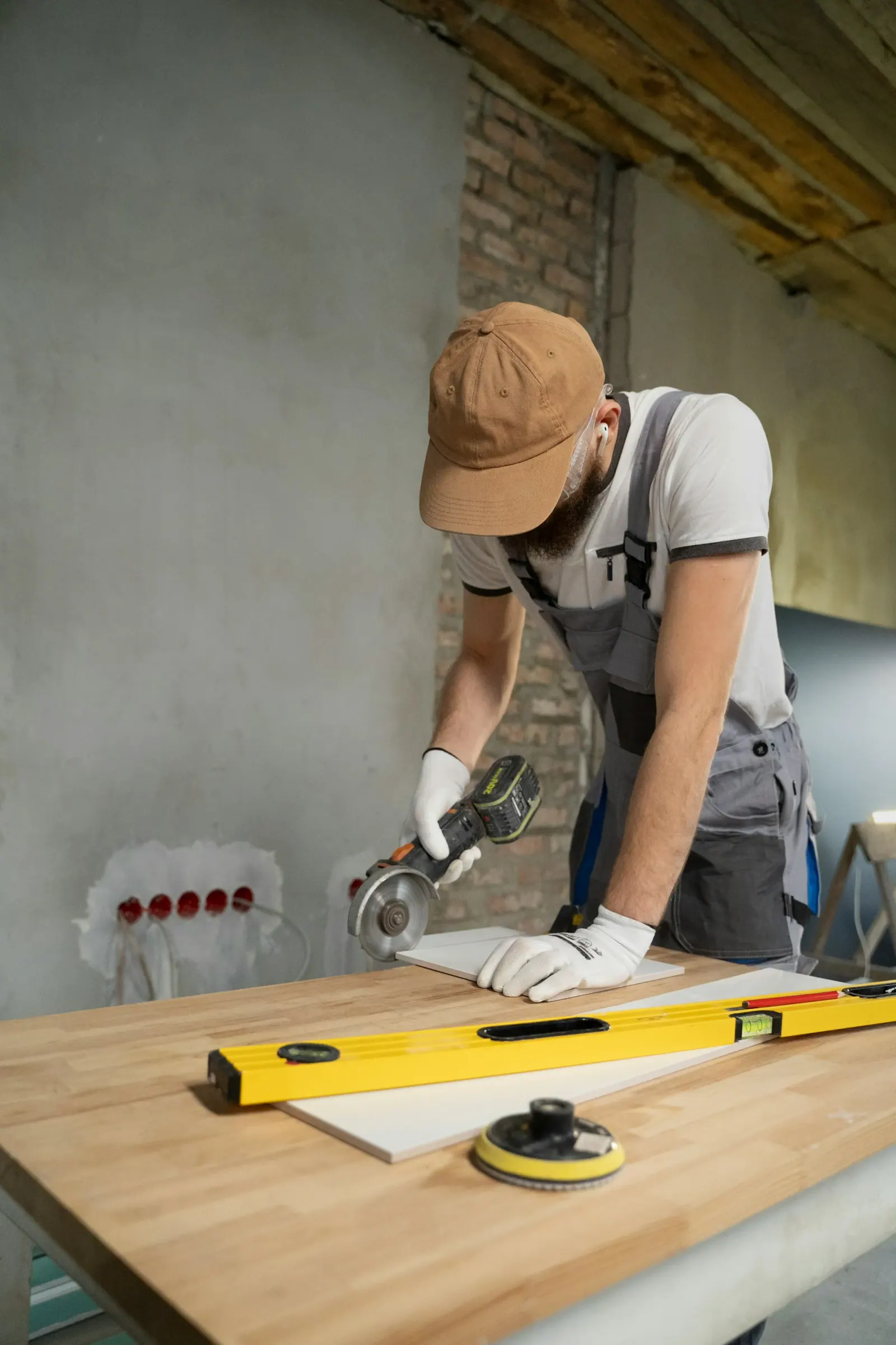 Tradesman cutting tile with an angle grinder