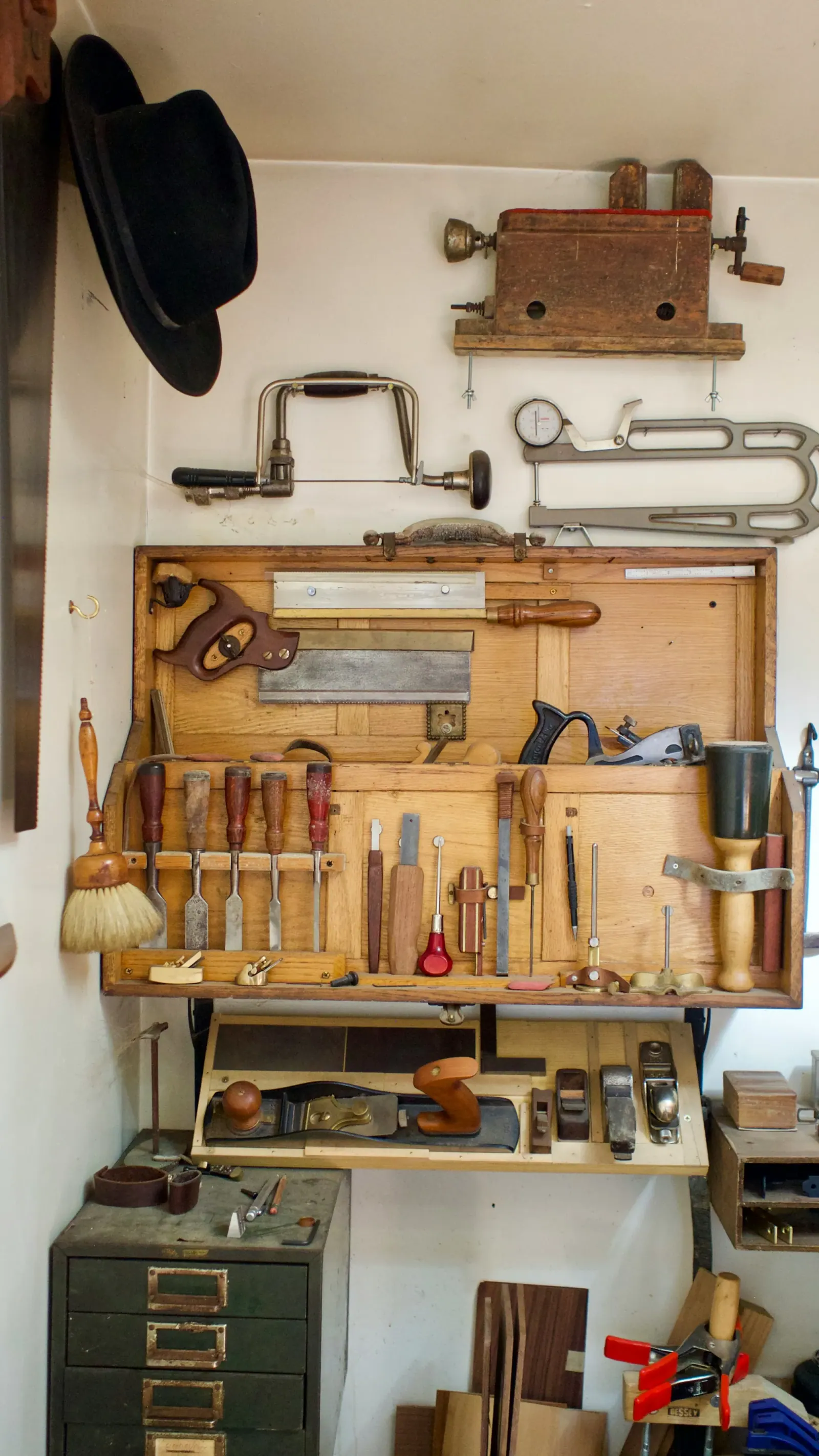Pegboard with hand saws, chisels and hand tools hanging in rows