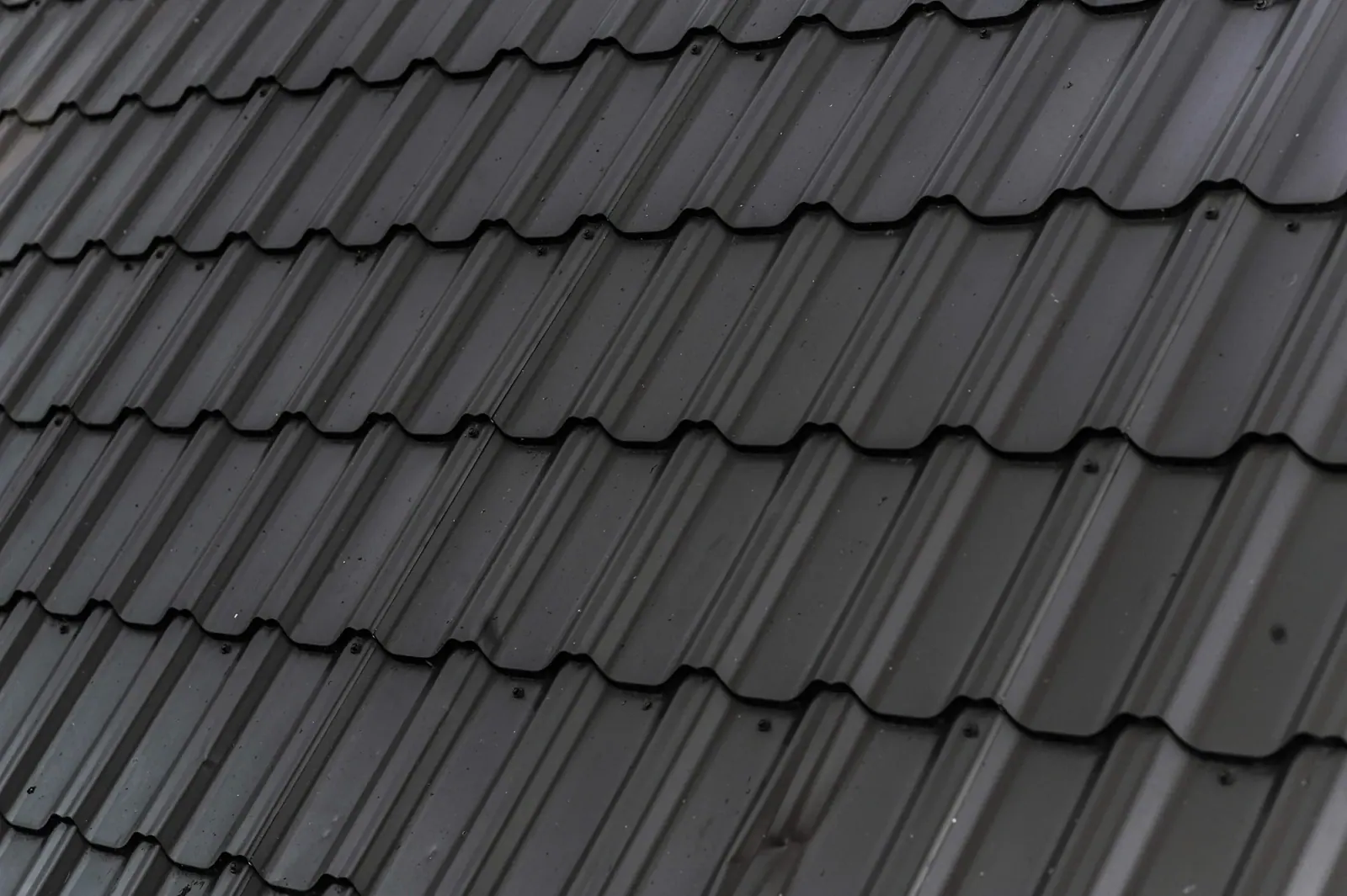 Close view of new dark roof shingles in rows