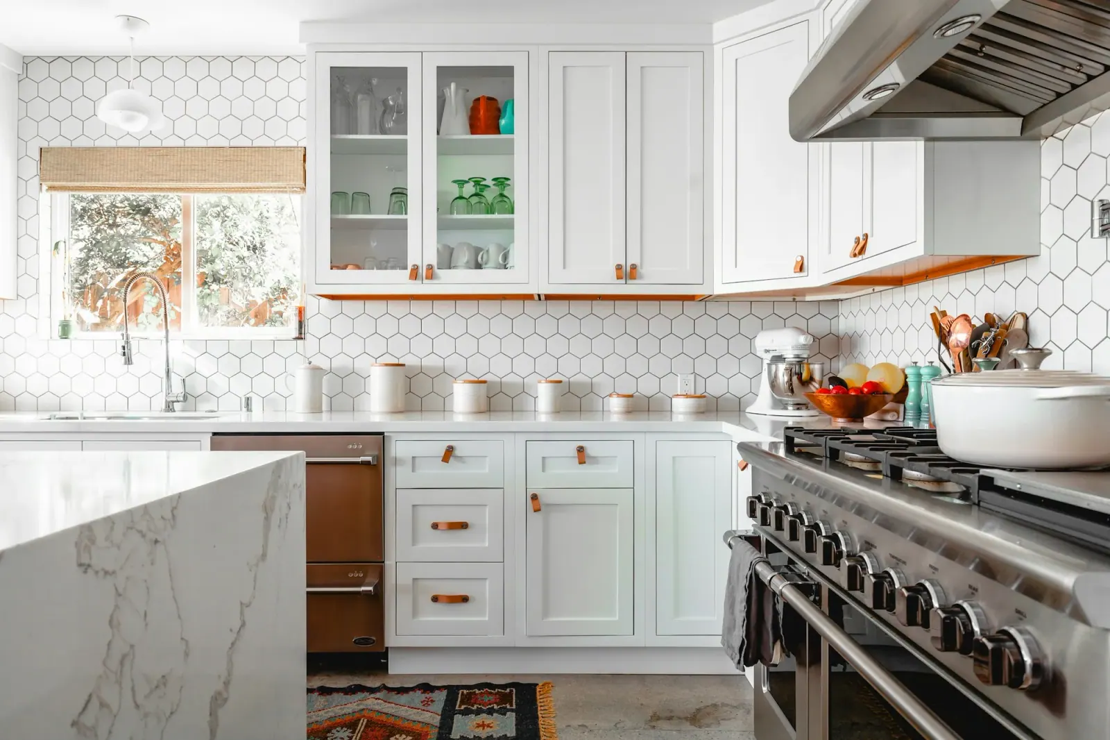 Bright white kitchen with clean counters and a marble island
