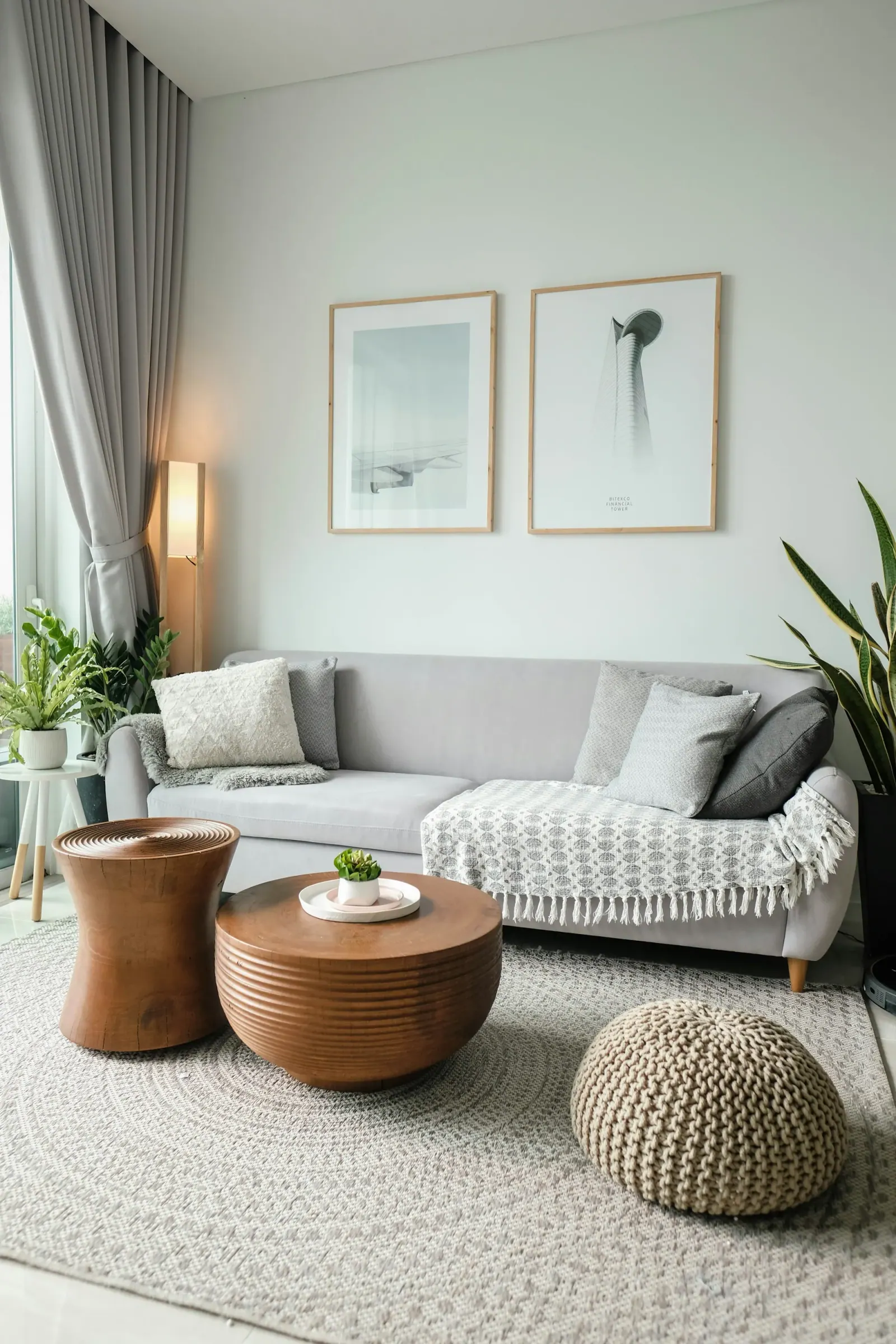 Tidy living room with a light sofa, cushions and plants